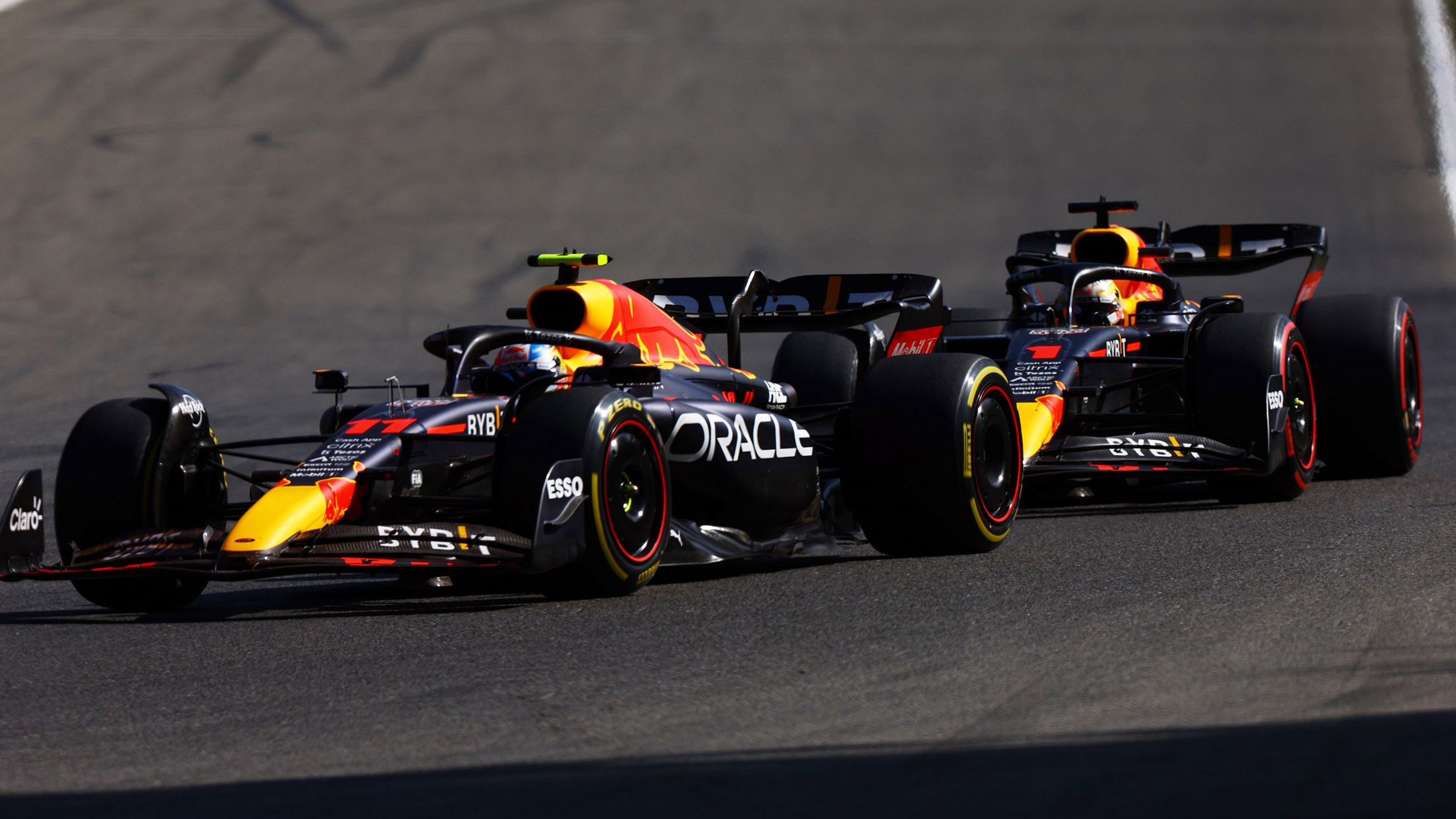 SPA, BELGIUM - AUGUST 28: Sergio Perez of Mexico driving the (11) Oracle Red Bull Racing RB18 leads Max Verstappen of the Netherlands driving the (1) Oracle Red Bull Racing RB18 during the F1 Grand Prix of Belgium at Circuit de Spa-Francorchamps on August 28, 2022 in Spa, Belgium. (Photo by Mark Thompson/Getty Images)