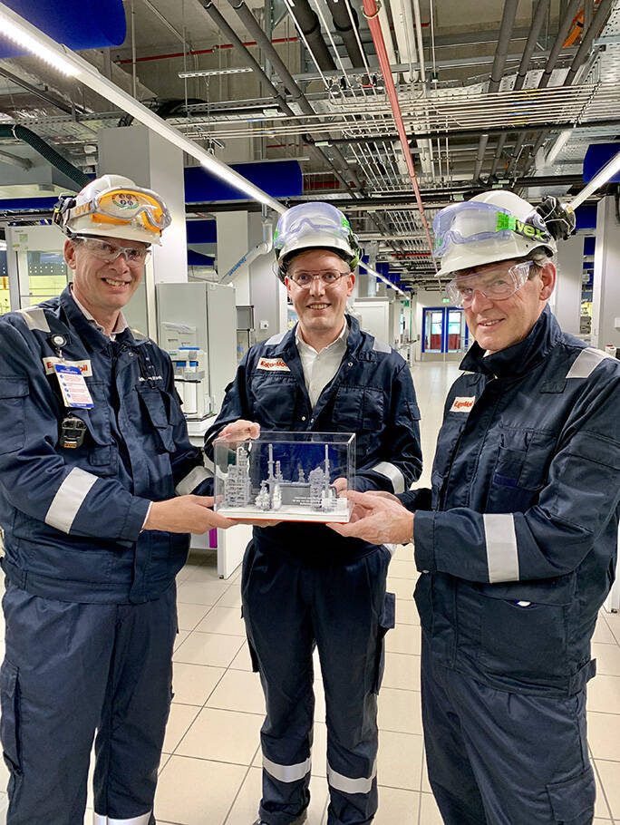 Image Foto — Raffinaderijdirecteur Erik van Beek (l) overhandigt een schaalmodel van de hydrocracker aan wethouders Arno Bonte (m) en Arjan van Gils (r).